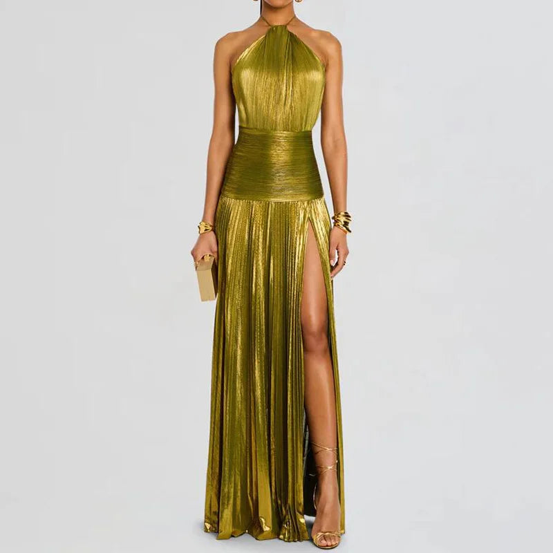 Model wearing gold pleated halter maxi dress, front view showing halter neckline, fitted bodice, and elegant floor-length silhouette