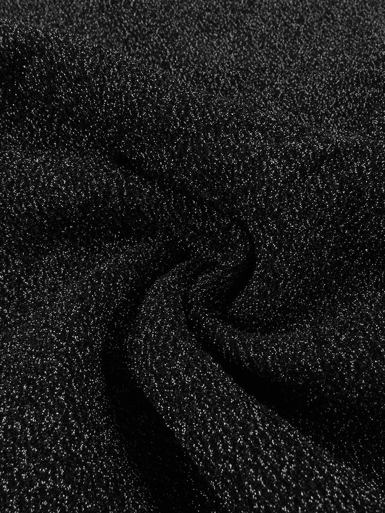 Close-up detail shot of premium black fabric texture showing material quality and weave pattern